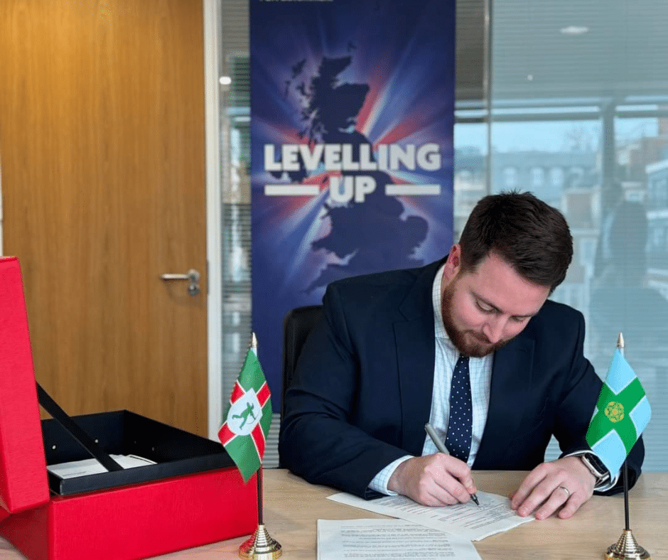 Image of Jacob Young the Levelling Up Minister signing the regulations for the authority to be established.