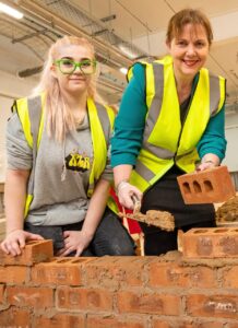 Pictured: East Midlands Mayor Claire Ward, centre, with construction student Lily Smith