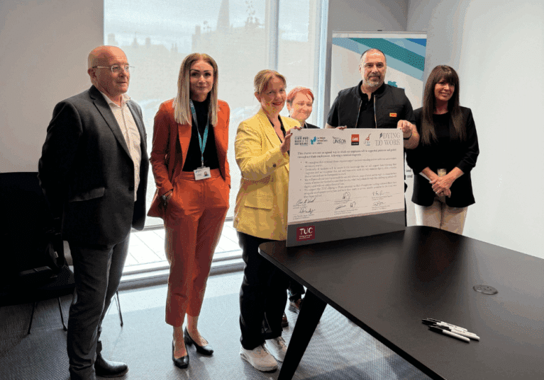 Mayor Claire Ward, Amy Harhoff and representatives from the Trade Unions hold up the signed Dying to Work Charter at EMCCA's office in Chesterfield.