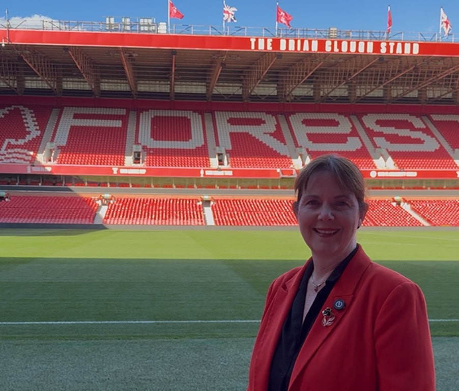 Mayor of the East Midlands, Claire Ward, stands beside the pitch inside Nottingham Forest Football Club's City Ground stadium.