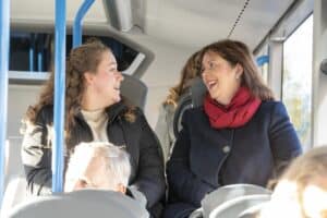 Mayor Claire Ward, right, chats to passenger on a bus