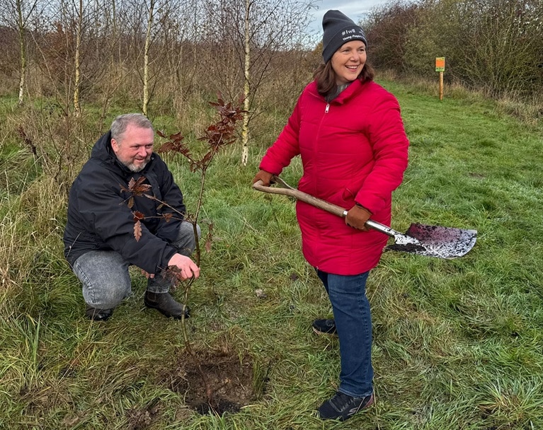 Mayor Claire Ward plants a tree during her woodland visit to the Young People's Forest at Mead.