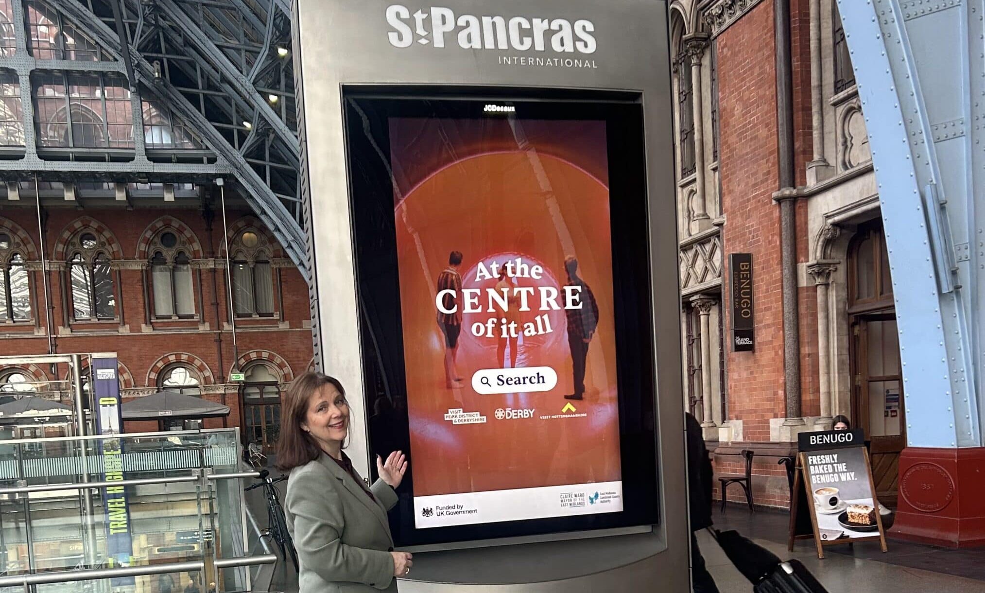 Mayor Claire Ward with a digital advertisement promoting the Centre of it All campaign at London's St Pancras International railway station.