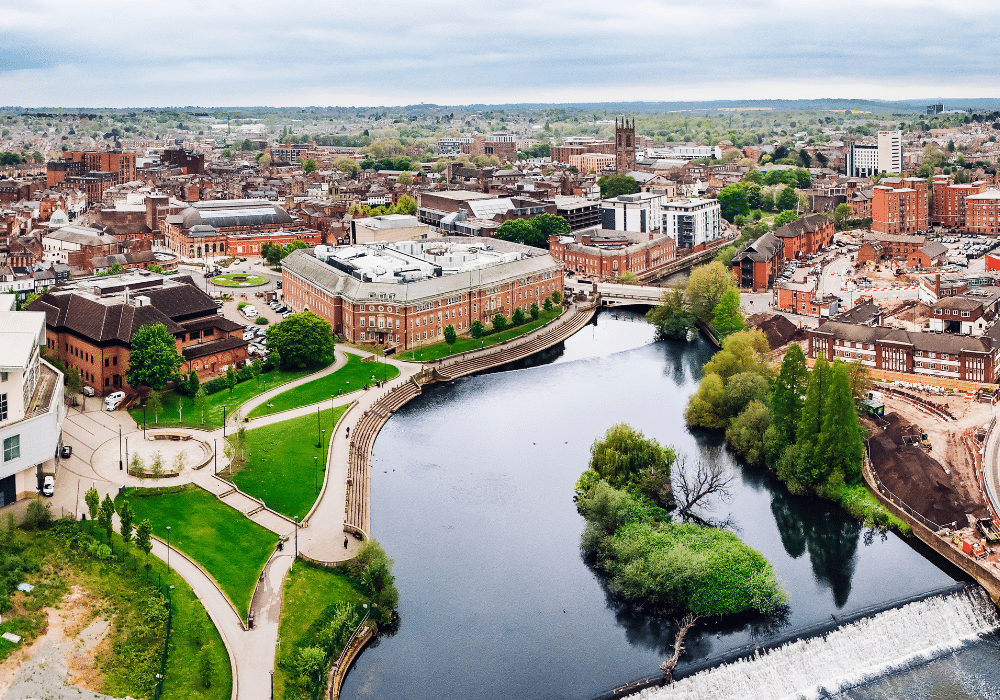 An aerial shot of Derby city centre, with the river in the foreground and the cathedral in the background