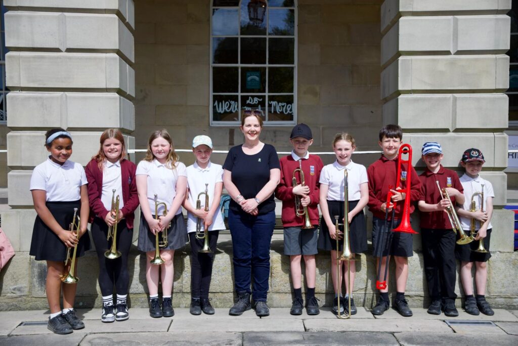 The Mayor with members of the Harpur Hill Primary School brass band, who performed as she arrived at the finish line.
