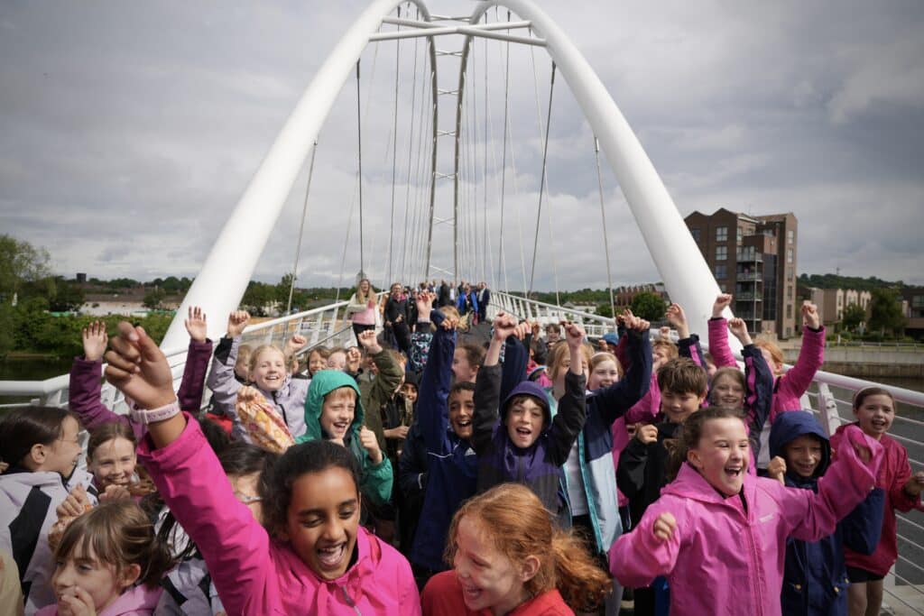 Schoolchildren celebrate the opening of the bridge.