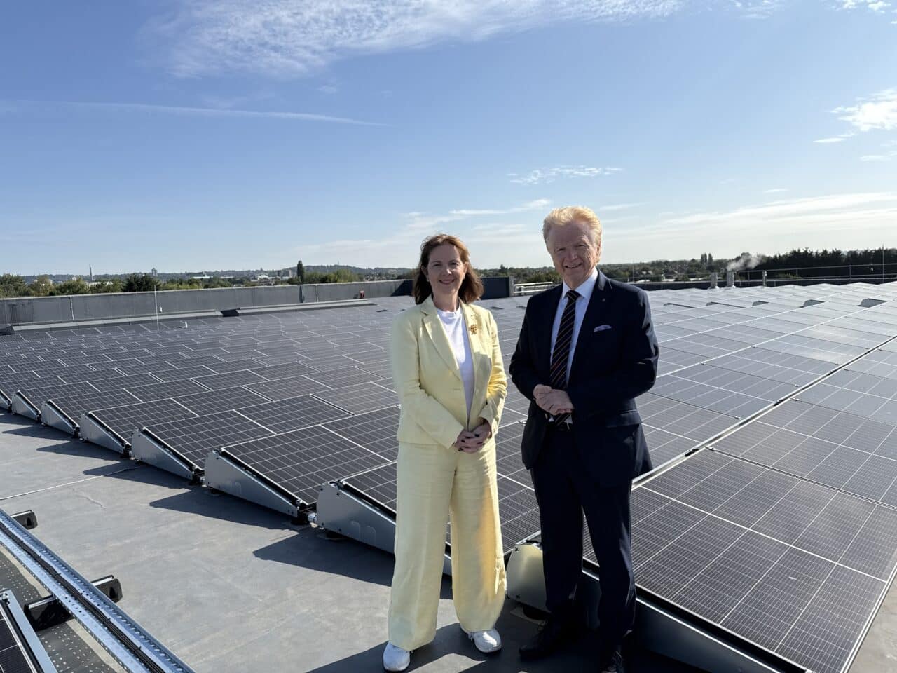 Mayor Claire Ward and Cllr Neil Clarke standing in front of the solar panels that have been installed on Rushcliffe Arena