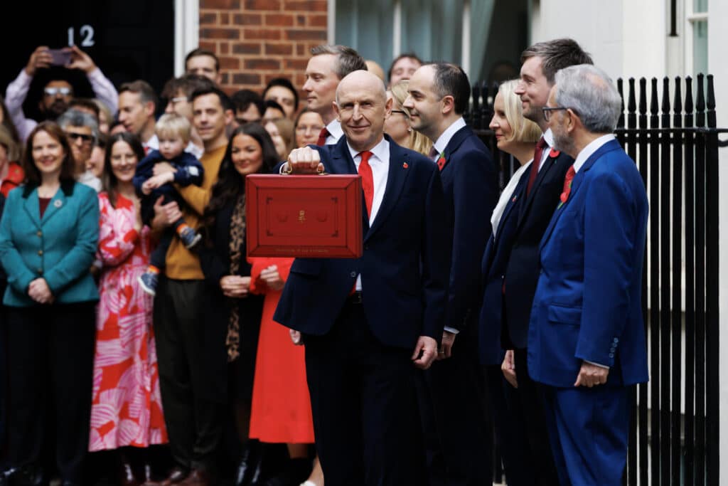 Chancellor John Healy holds the red budget briefcase outside No10 with Mayor Claire in the background