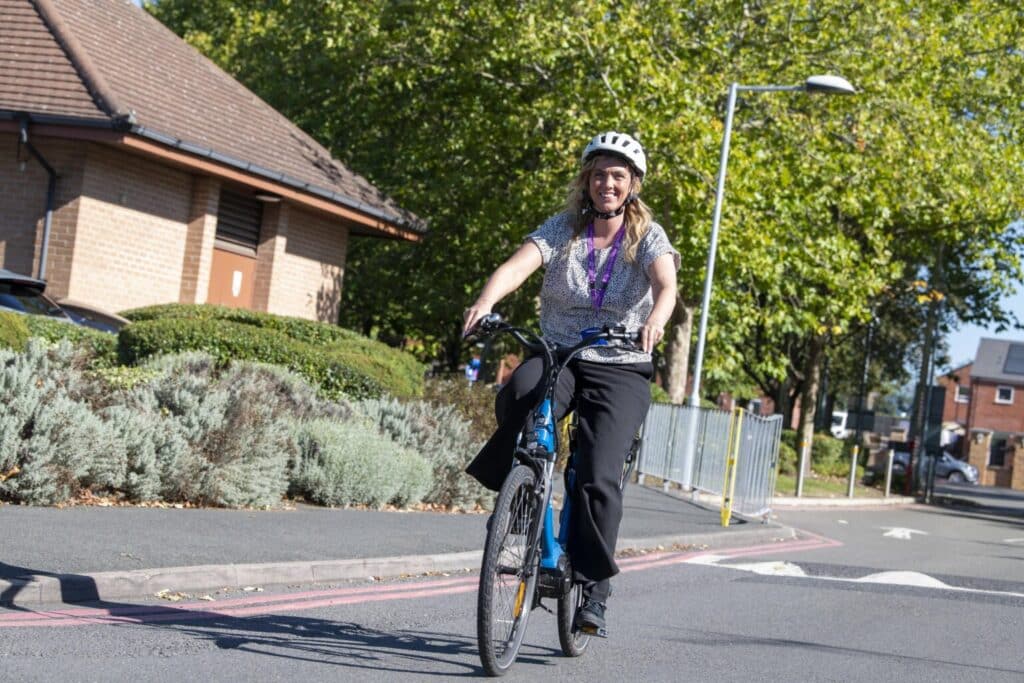 Jo Baker, from Highbury Hospital, tries out on of the new e-bikes.