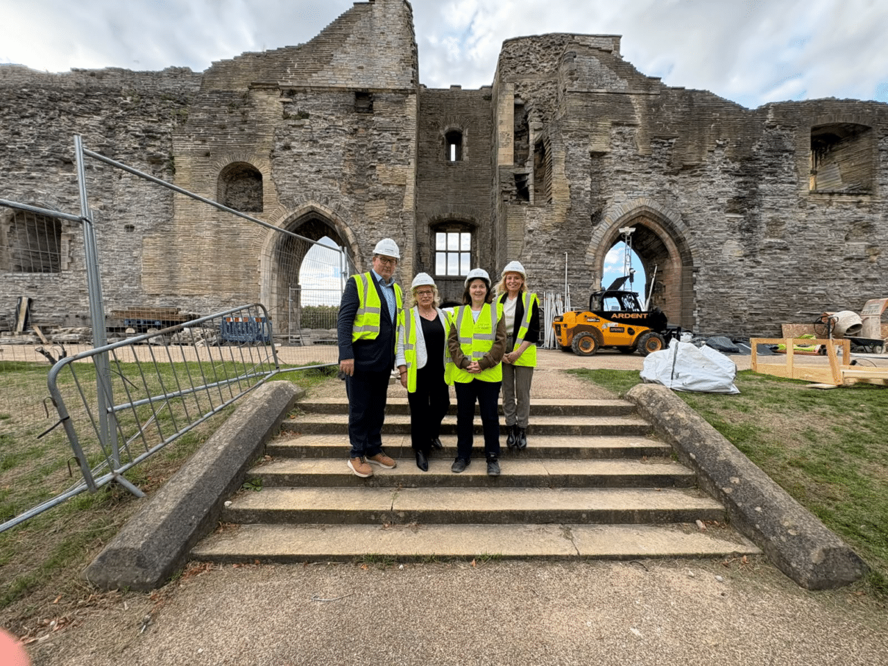 Mayor Claire joins partners from Newark and Sherwood District Council on the steps of the Newark Castle Gatehouse. They are wearing high-vis vests and hard hats.
